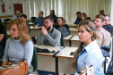 fotos do curso de integração em que aparecem os novos servidores e apresentações feitas por coordenadores e chefes de núcleos.