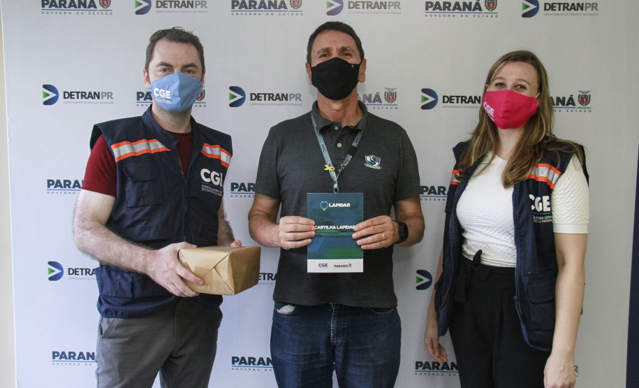 equipe enrega cartilhas físicas a representantes de órgãos do governo.